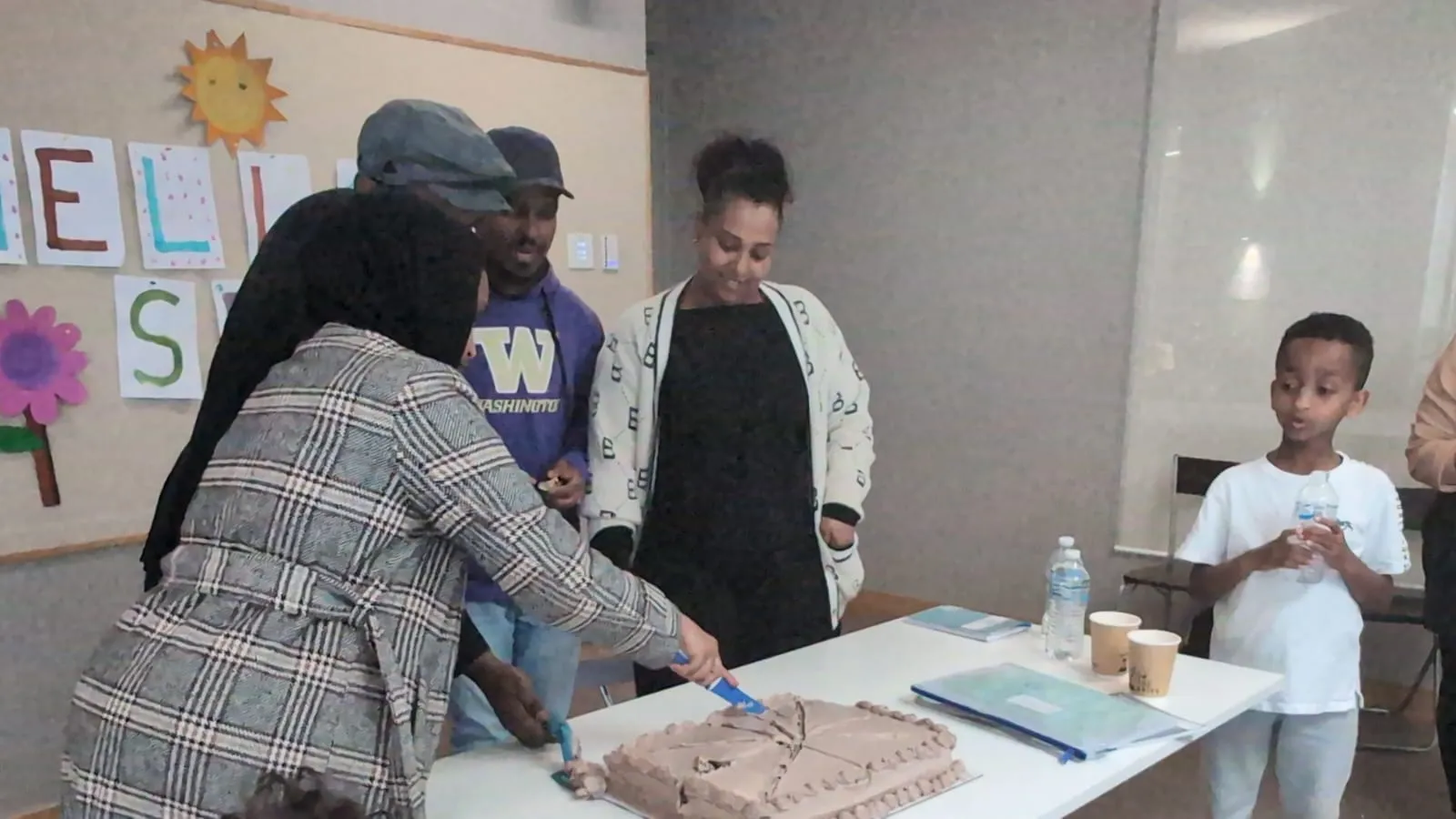 Volunteers preparing food at a table during an ELSP community event
